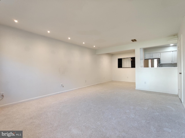 unfurnished room featuring light colored carpet