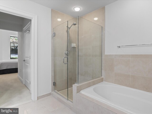 bathroom with separate shower and tub