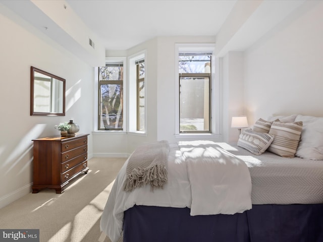 carpeted bedroom with baseboards and visible vents