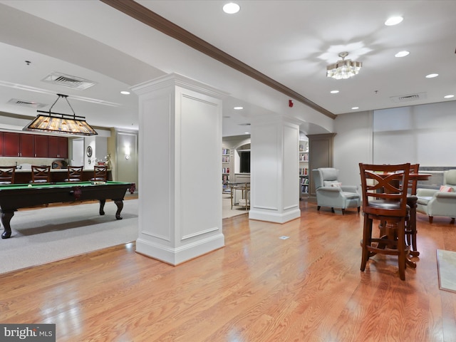 rec room with decorative columns, crown molding, light hardwood / wood-style flooring, and billiards