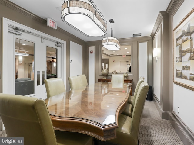 dining room with french doors, dark carpet, and crown molding