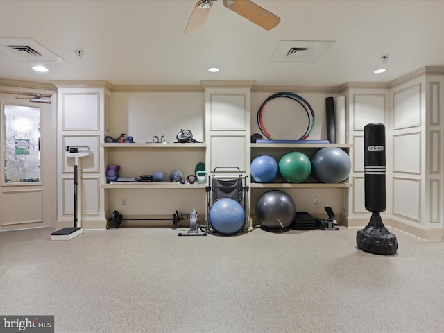 workout area with carpet floors, ceiling fan, and crown molding