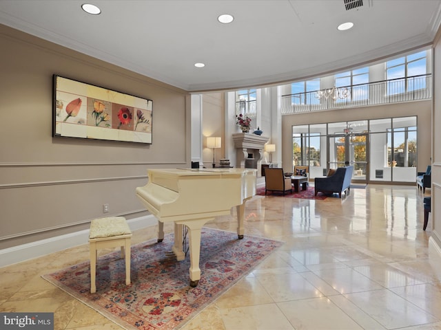 misc room with a notable chandelier, a healthy amount of sunlight, and ornamental molding