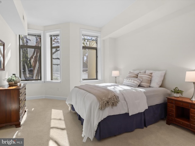 bedroom featuring light carpet