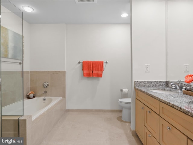 bathroom with tile patterned floors, vanity, tiled bath, and toilet