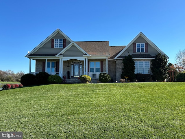 view of front of home with a porch and a front lawn