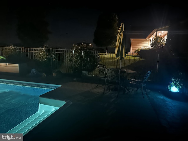 pool at night with a patio