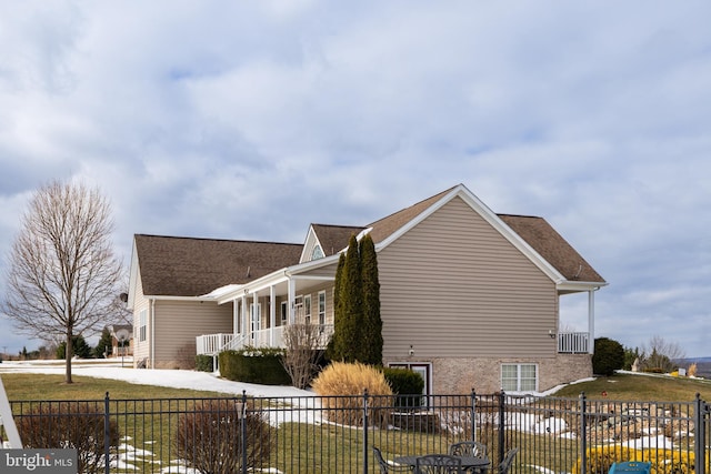 view of property exterior with covered porch and a yard