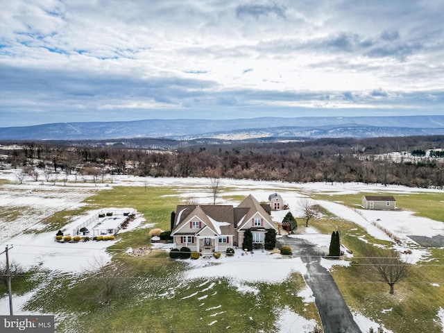 snowy aerial view featuring a mountain view