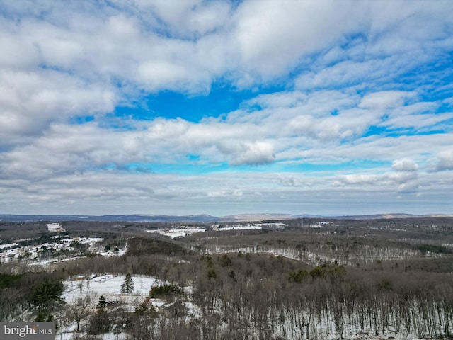 snowy aerial view with a mountain view