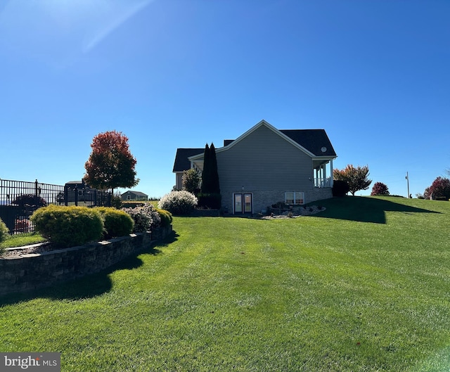 view of side of property featuring a yard