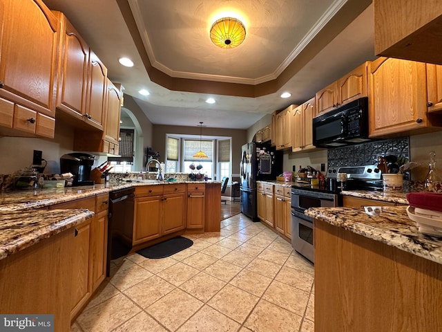 kitchen featuring black appliances, light stone countertops, decorative light fixtures, a raised ceiling, and ornamental molding