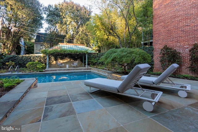outdoor pool featuring a patio area