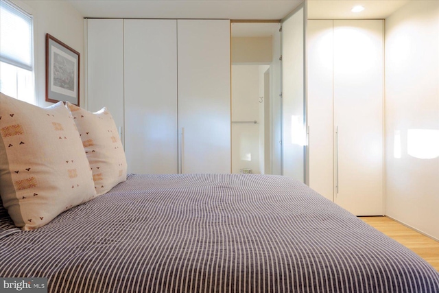 unfurnished bedroom with light wood finished floors