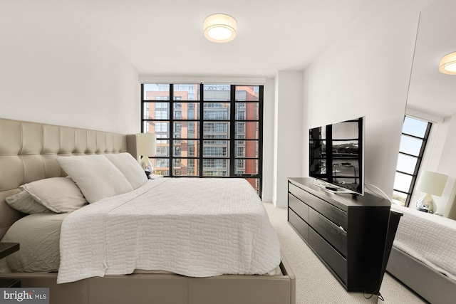 bedroom featuring light carpet