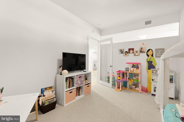 recreation room with light carpet