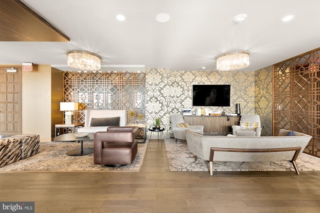 living room with hardwood / wood-style floors and a chandelier