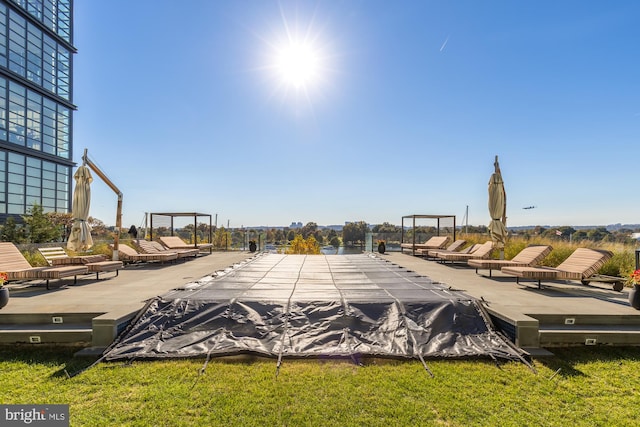 view of swimming pool with a wooden deck and a lawn