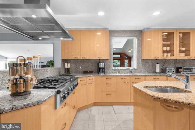 kitchen featuring light brown cabinetry, sink, ventilation hood, and light stone counters