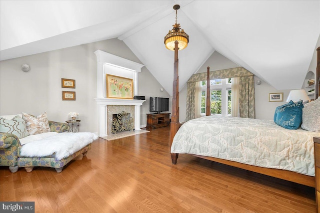 bedroom featuring lofted ceiling and wood-type flooring