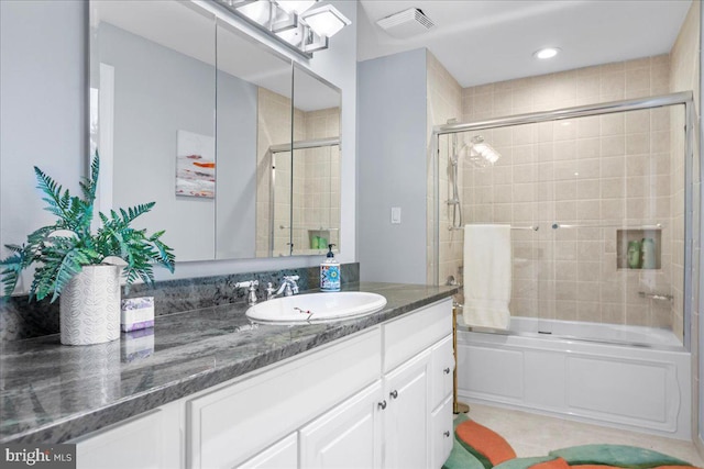 bathroom with vanity and bath / shower combo with glass door