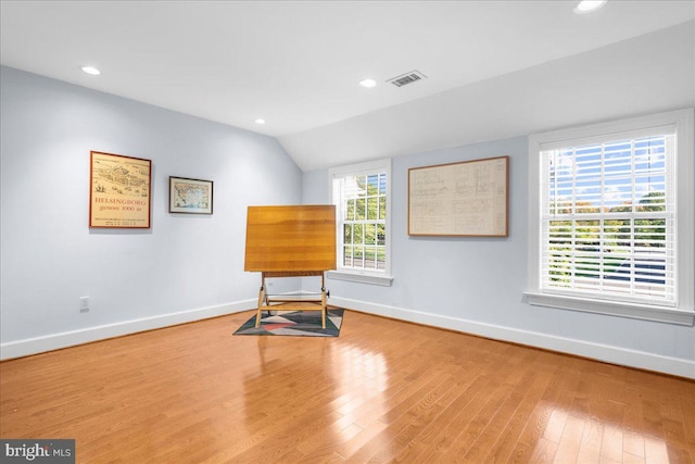 interior space with lofted ceiling, hardwood / wood-style flooring, and plenty of natural light