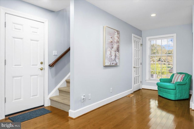 foyer with dark hardwood / wood-style floors