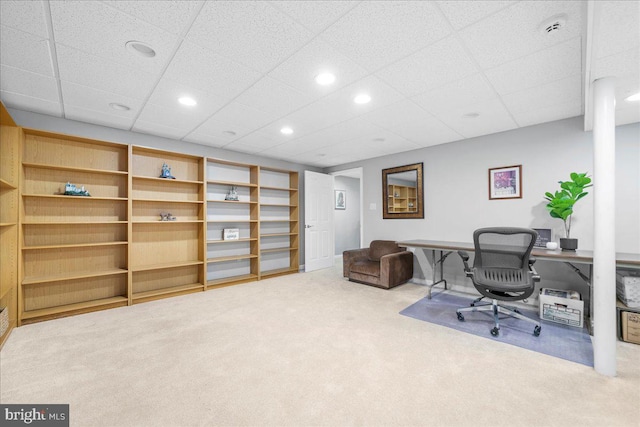 carpeted office with a drop ceiling