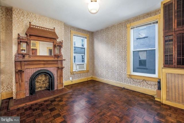 unfurnished living room with a tile fireplace, cooling unit, and dark parquet flooring