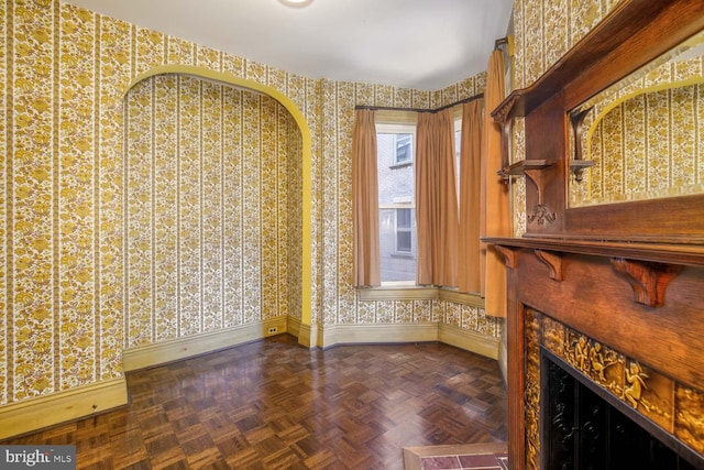 unfurnished living room featuring dark parquet flooring