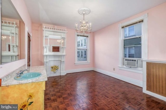 unfurnished dining area with a chandelier, cooling unit, sink, and dark parquet flooring