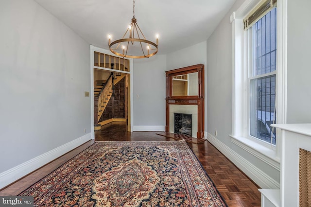 interior space featuring a notable chandelier and dark parquet flooring