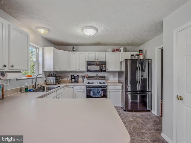 kitchen with white cabinetry, a textured ceiling, stainless steel refrigerator, stove, and sink