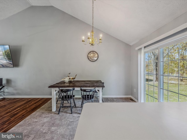 dining room featuring a notable chandelier, wood-type flooring, a textured ceiling, and vaulted ceiling