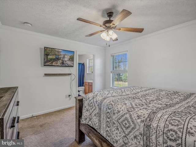 bedroom featuring a textured ceiling, light carpet, ceiling fan, and ensuite bath