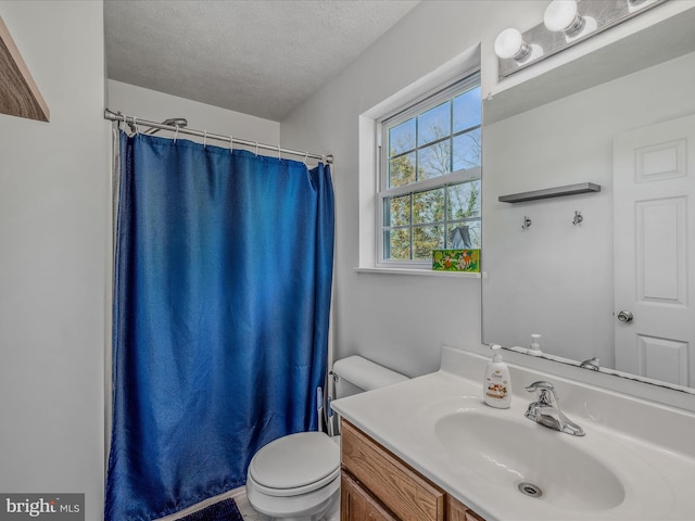 bathroom with curtained shower, vanity, a textured ceiling, and toilet