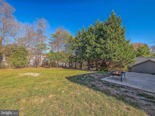 view of yard featuring a patio and an outdoor fire pit