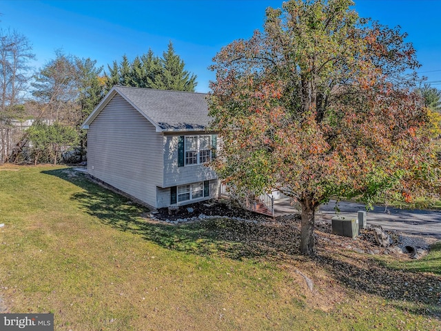 view of side of home featuring a lawn