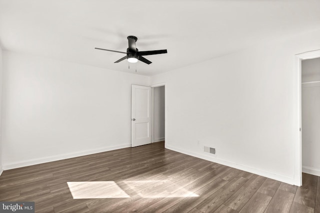 unfurnished bedroom featuring dark wood-type flooring and ceiling fan