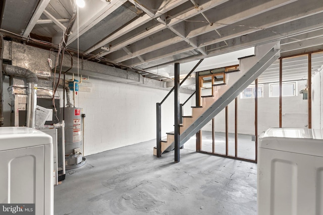 basement featuring water heater and washer and dryer