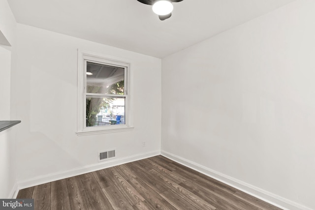 spare room with dark wood-type flooring