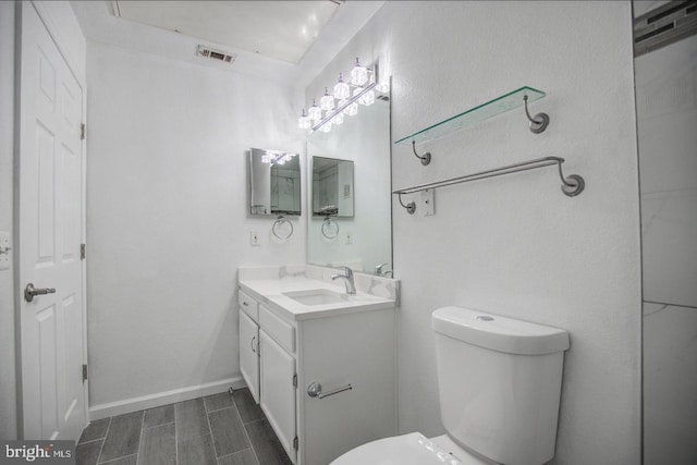 bathroom featuring vanity and toilet