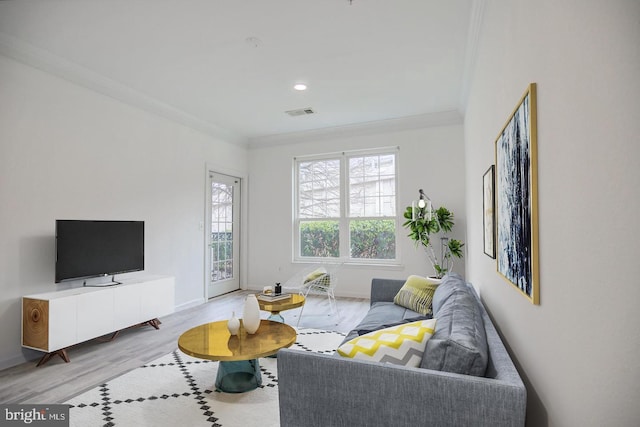 living room featuring ornamental molding and light wood-type flooring