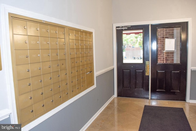 tiled entrance foyer with a mail area