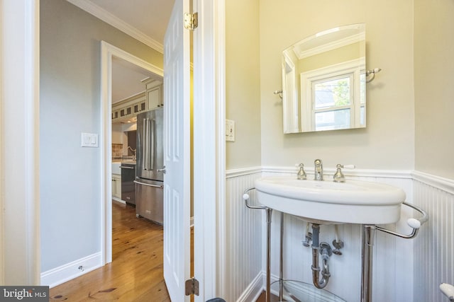 bathroom with ornamental molding and hardwood / wood-style floors