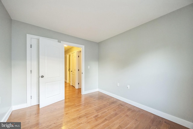 empty room with light hardwood / wood-style flooring