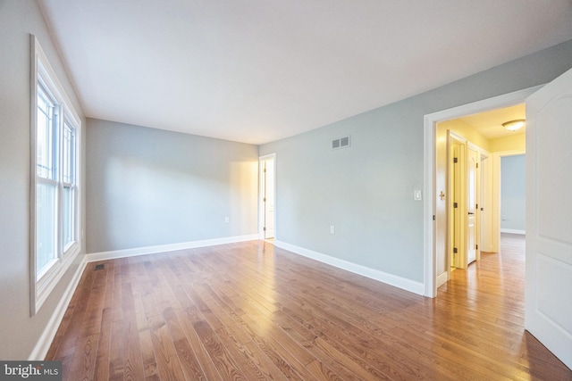 unfurnished room featuring hardwood / wood-style floors