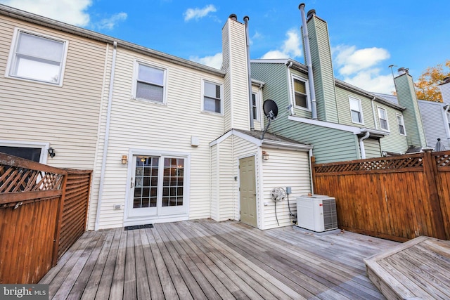 rear view of house featuring central AC and a wooden deck