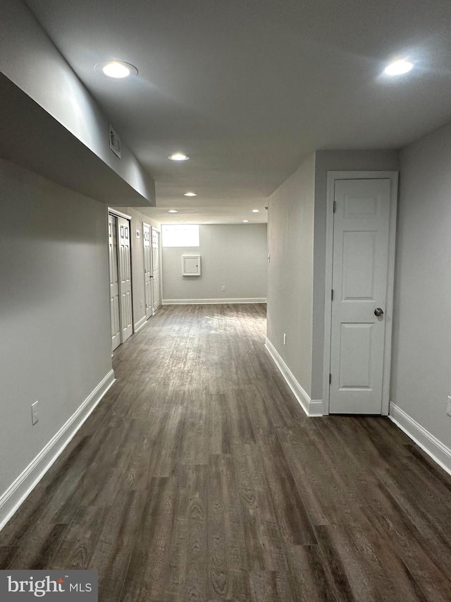 basement with dark wood-type flooring