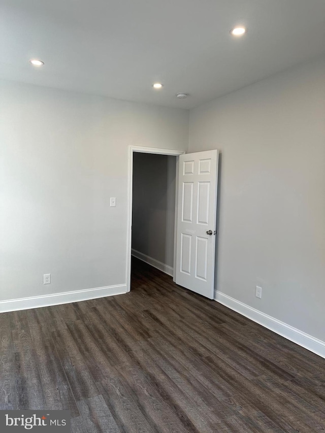 spare room featuring dark hardwood / wood-style flooring